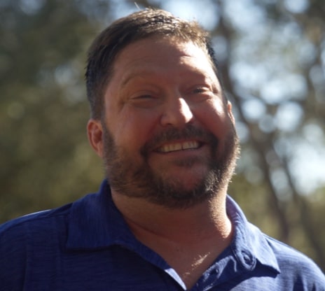 Portrait of Chris smiling outside